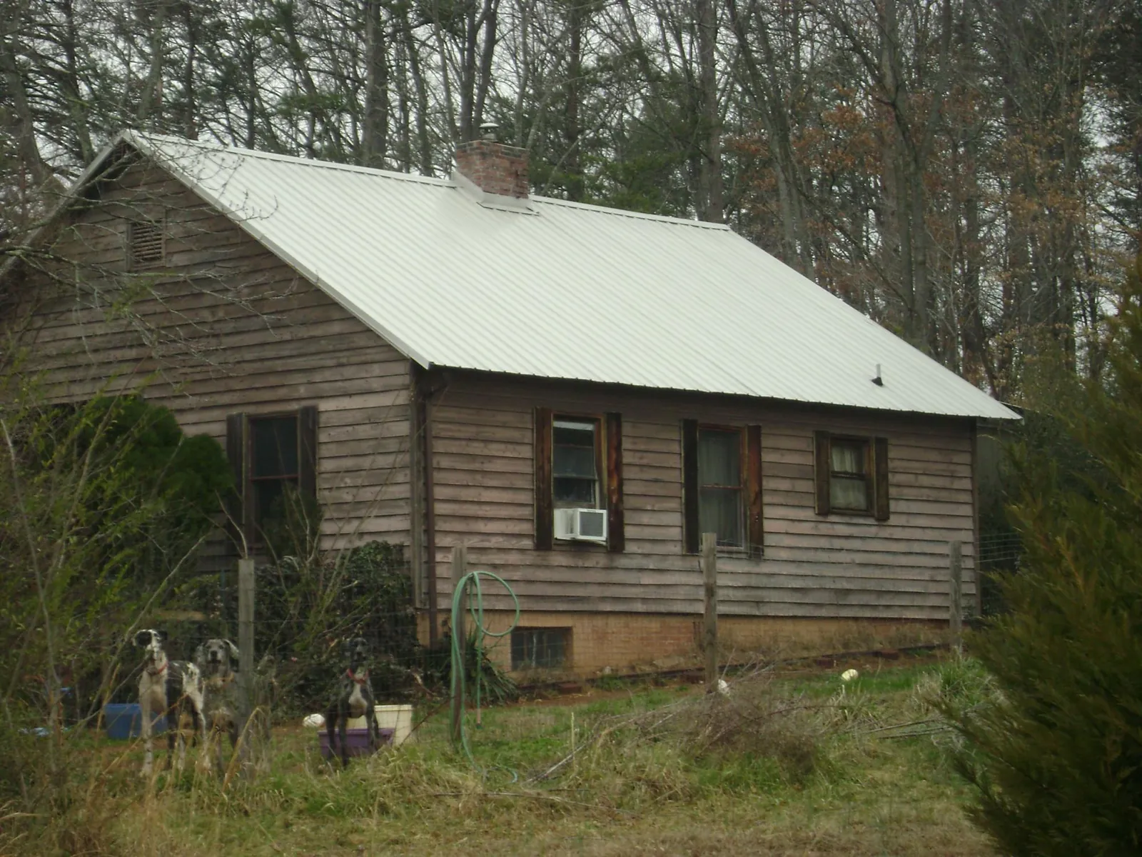 White metal roof on an old wood sided farmhouse, from a Asphalt Shingle Roof Repair job in Fayette